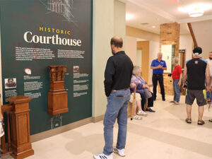 a man reads about the history of the Cass County Administration building at the grand reopening on October 11, 2024